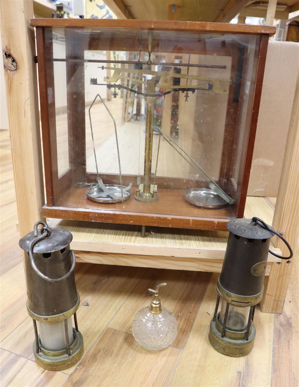 A mahogany cased set of Apothecary scales, two miners lamps and a cut glass atomiser